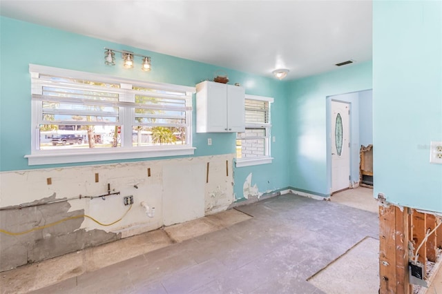 kitchen featuring white cabinets and visible vents