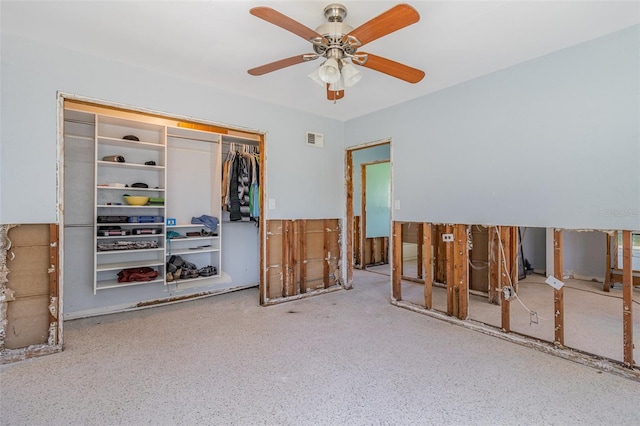 interior space with visible vents, speckled floor, and ceiling fan