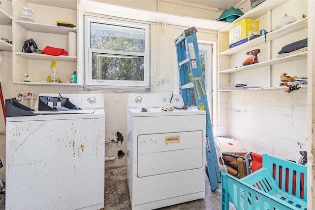 laundry area with washing machine and clothes dryer and laundry area