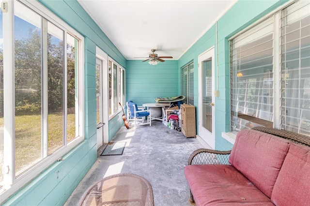 sunroom / solarium featuring a ceiling fan