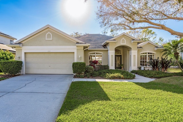 view of front of property featuring stucco siding, a garage, concrete driveway, and a front yard