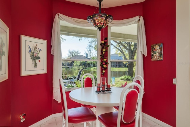 dining room featuring baseboards and light tile patterned flooring