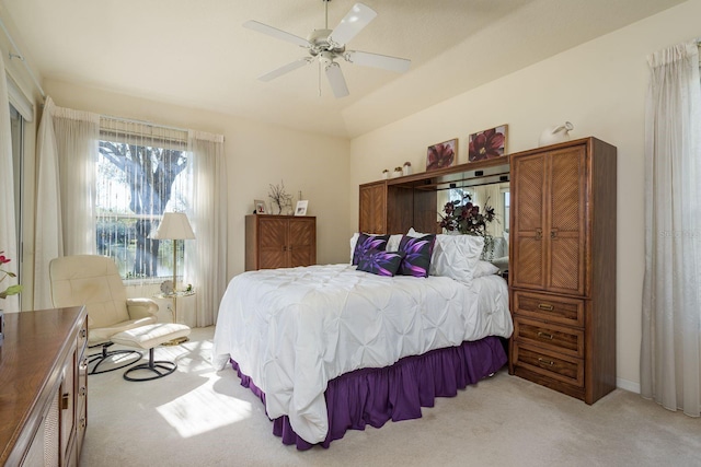 bedroom with light colored carpet, ceiling fan, and vaulted ceiling