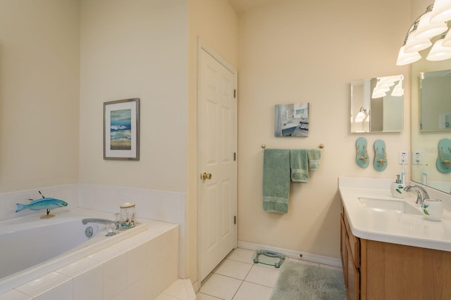 bathroom with vanity, tile patterned floors, a garden tub, and baseboards