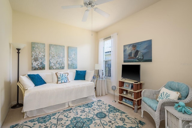 carpeted living room featuring baseboards and a ceiling fan