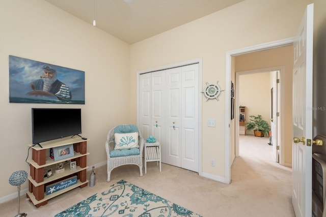 living area with carpet flooring and baseboards