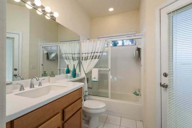 bathroom with tile patterned flooring, toilet, vanity, and bath / shower combo with glass door