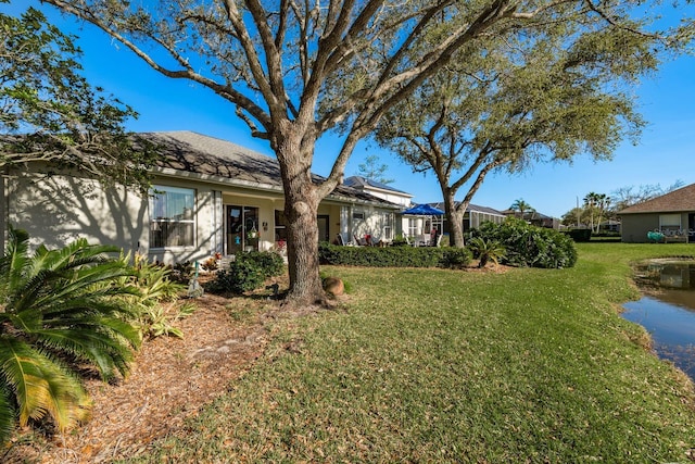 view of front of house featuring a front yard and stucco siding