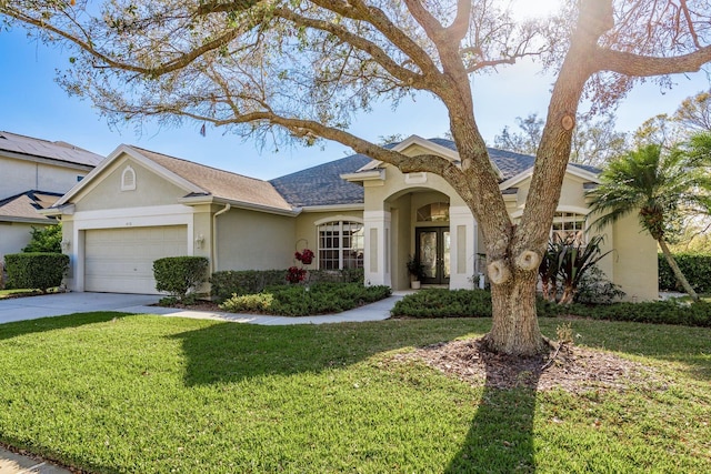 view of front of property with a shingled roof, concrete driveway, a front yard, stucco siding, and a garage