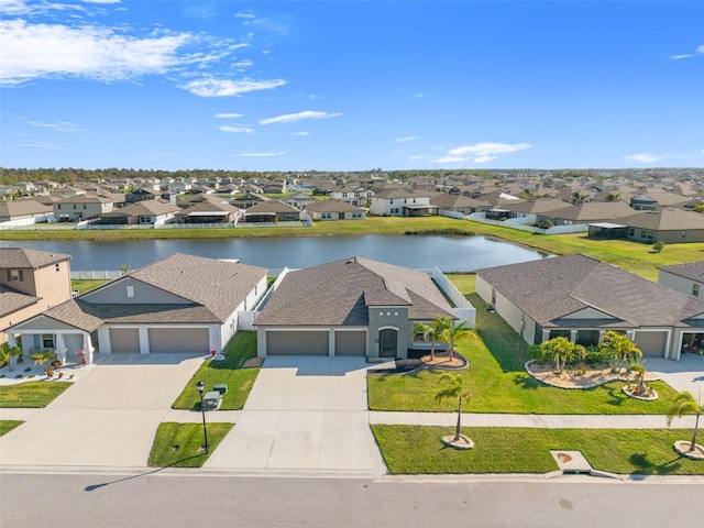 drone / aerial view with a residential view and a water view