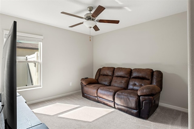 living room with a ceiling fan, carpet, and baseboards