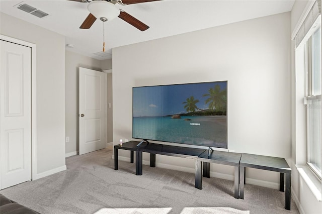 home office featuring baseboards, visible vents, a ceiling fan, and carpet