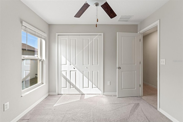 unfurnished bedroom with a closet, visible vents, baseboards, and carpet