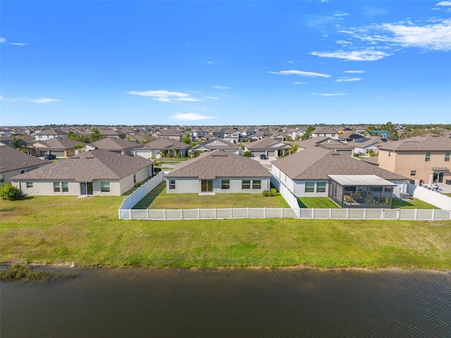 drone / aerial view with a residential view and a water view