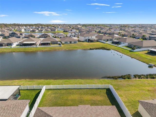 drone / aerial view featuring a residential view and a water view