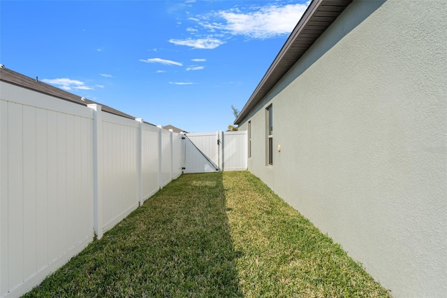 view of yard with fence and a gate