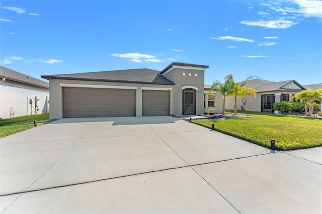 view of front facade with stucco siding, driveway, a front yard, and an attached garage