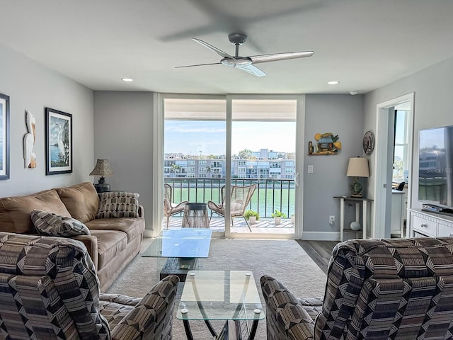 living room with baseboards, floor to ceiling windows, recessed lighting, wood finished floors, and a ceiling fan