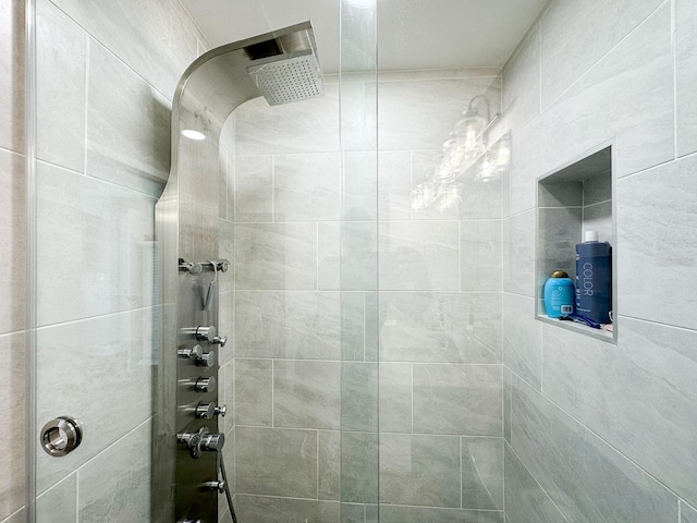 bathroom with a tile shower