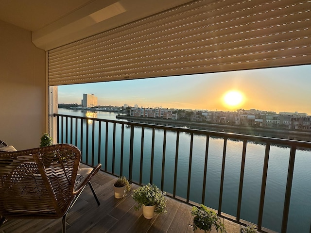 balcony featuring a city view and a water view