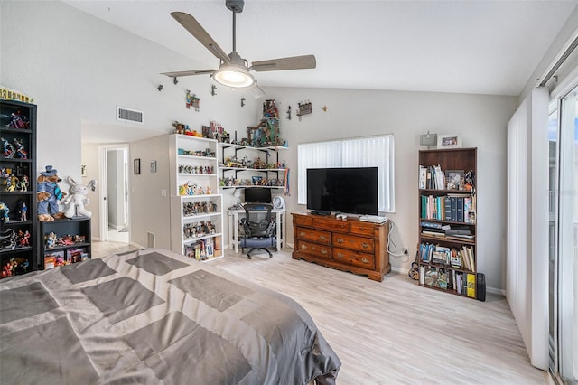 bedroom featuring a ceiling fan, lofted ceiling, wood finished floors, and visible vents