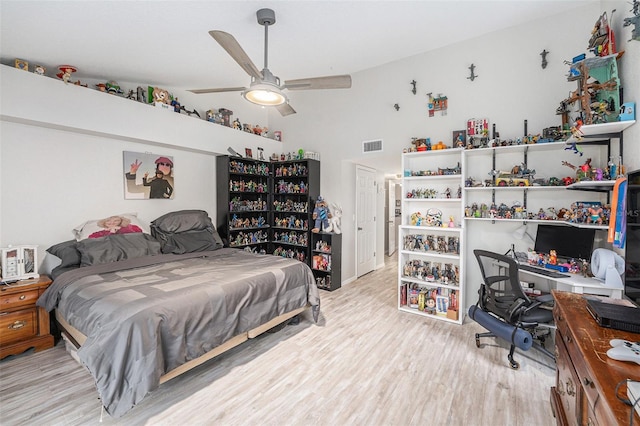 bedroom with lofted ceiling, visible vents, light wood finished floors, and ceiling fan