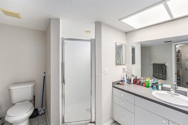 full bath with vanity, visible vents, a shower stall, a textured ceiling, and toilet