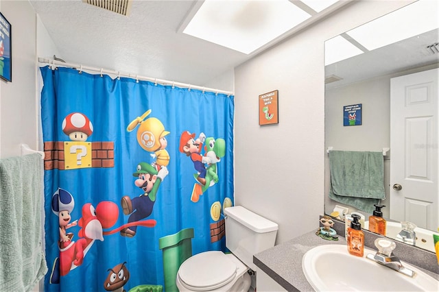 bathroom featuring vanity, curtained shower, toilet, and visible vents