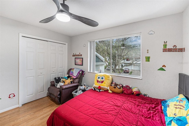 bedroom featuring ceiling fan, a closet, and wood finished floors