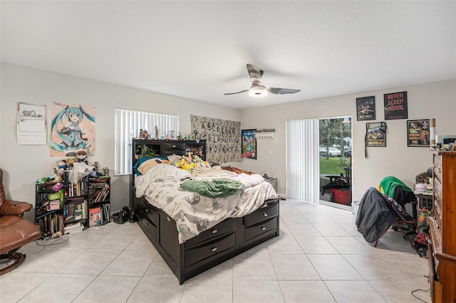 bedroom featuring access to exterior, light tile patterned flooring, and ceiling fan