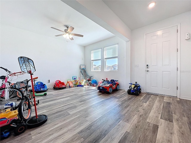 recreation room featuring a ceiling fan and wood finished floors