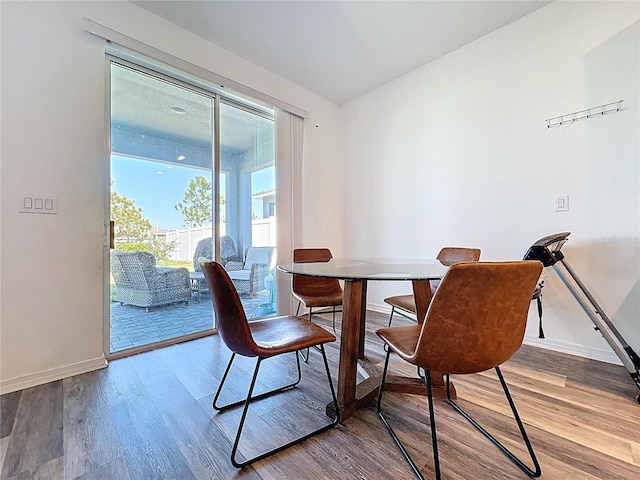 dining room featuring baseboards and wood finished floors