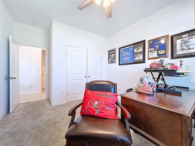 living area with baseboards, ceiling fan, and carpet flooring