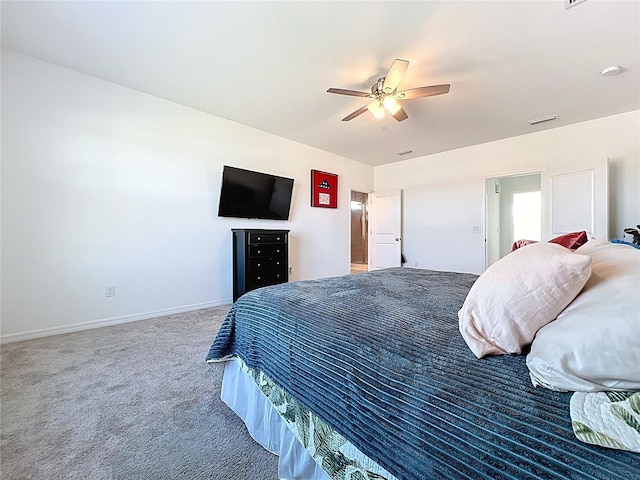 carpeted bedroom featuring visible vents, baseboards, and a ceiling fan