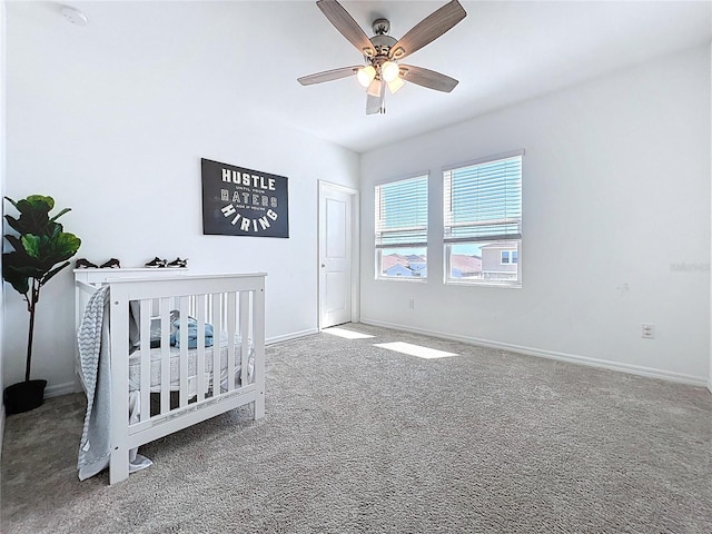 unfurnished bedroom with baseboards, carpet, and a ceiling fan