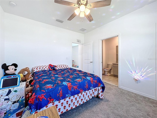 bedroom featuring ensuite bath, visible vents, a ceiling fan, and carpet