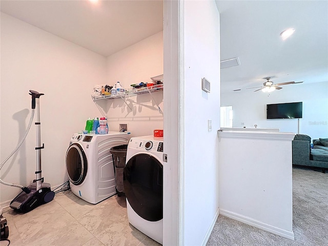 clothes washing area featuring baseboards, ceiling fan, laundry area, and washer and clothes dryer