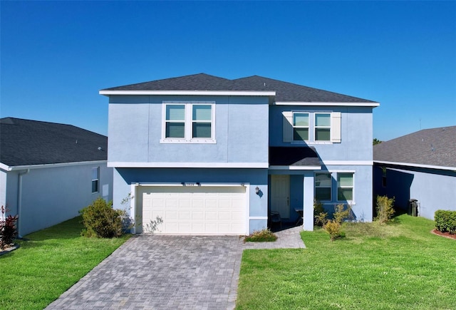 view of front of property with stucco siding, an attached garage, decorative driveway, and a front lawn