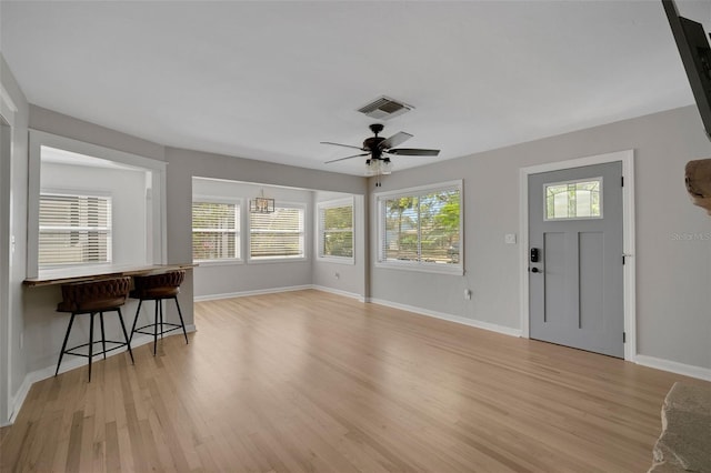 entrance foyer with visible vents, ceiling fan, baseboards, and light wood-style floors