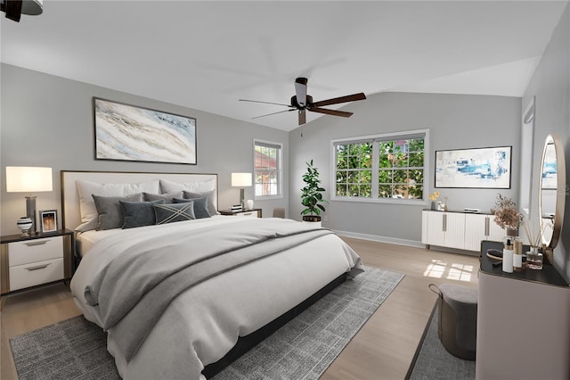 bedroom featuring vaulted ceiling, radiator heating unit, baseboards, and light wood finished floors