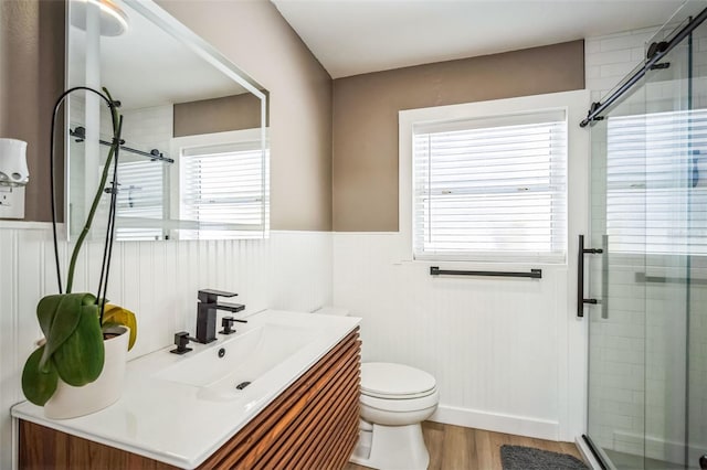 full bath with toilet, a stall shower, and vanity