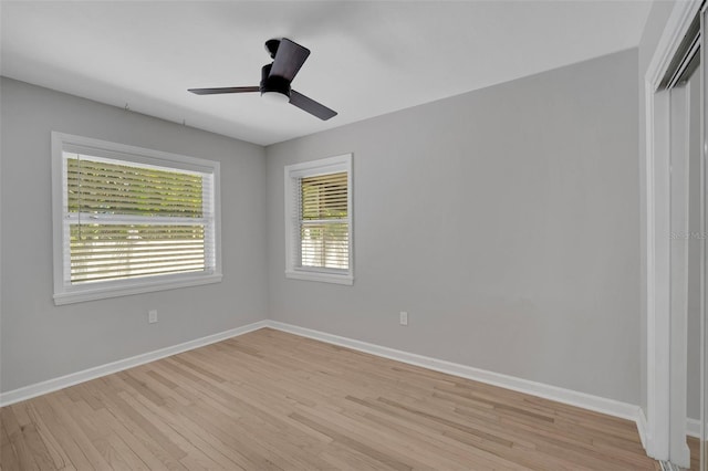 empty room with baseboards, light wood-style floors, and ceiling fan