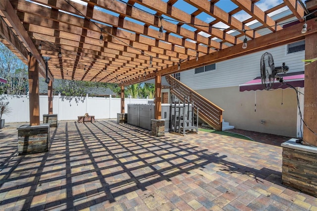 view of patio / terrace featuring stairway, a pergola, and fence