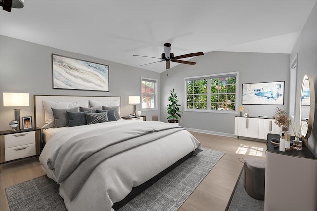 bedroom with light wood finished floors, radiator, baseboards, and lofted ceiling