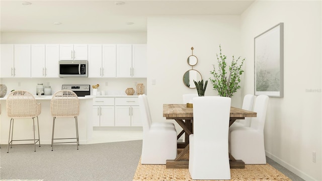 interior space with baseboards and light carpet