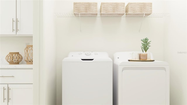 washroom with cabinet space and washing machine and clothes dryer