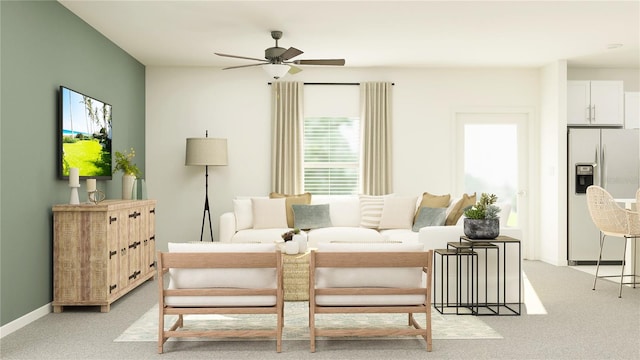 bedroom featuring refrigerator with ice dispenser, baseboards, and light carpet