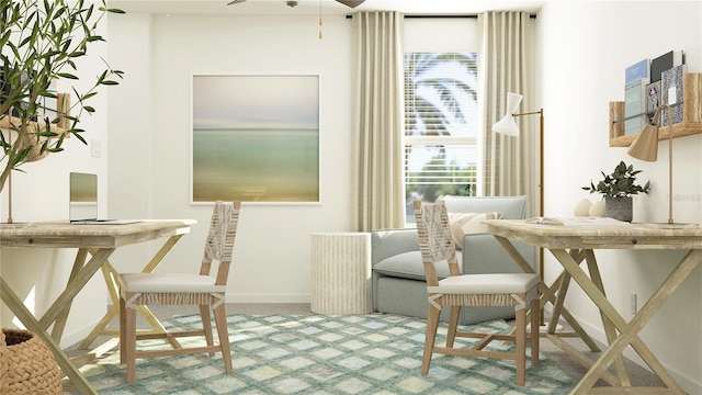 carpeted dining space featuring baseboards and ceiling fan