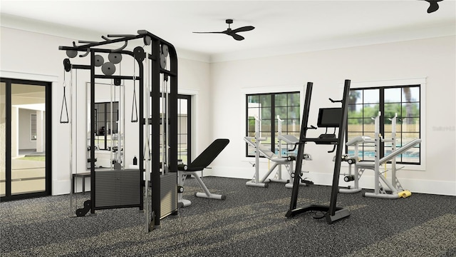 gym featuring plenty of natural light, baseboards, ceiling fan, and ornamental molding