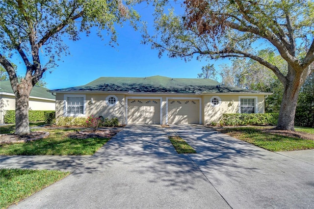 ranch-style home with a garage, driveway, and stucco siding